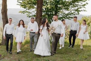 A group of people are walking in a field, with a bride and groom in the center photo