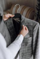 A man is hanging a jacket on a hanger photo