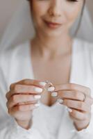 A woman is holding a ring in her hand photo