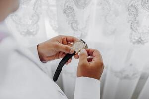 A man is wearing a watch and adjusting it photo