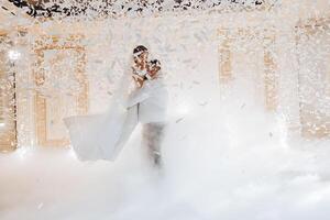 A bride and groom are dancing in the air in a snowstorm photo