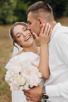 A bride and groom are kissing each other's lips photo