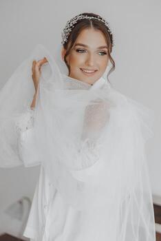 A woman is wearing a white dress and a veil photo