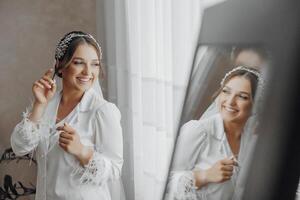 A woman is wearing a white dress and a headband photo