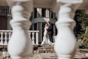 A couple is posing for a picture in front of a white railing photo