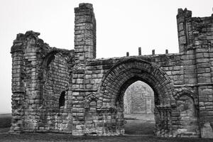 Ancient Stone Ruins in Fog in Tynemouth Priory and Castle photo