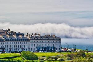 Coastal buildings with fog over the sea in Whitby, North Yorkshire photo