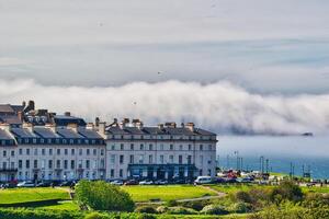 Coastal buildings with fog over the sea in Whitby, North Yorkshire photo