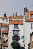 Quaint street with traditional buildings Robin Hood's Bay, Yorkshire photo