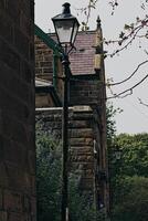 Vintage street lamp post in front of old stone building Robin Hood's Bay, Yorkshire photo