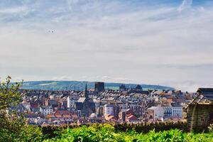 Panoramic view of a quaint town with church and hills in Whitby, North Yorkshire photo