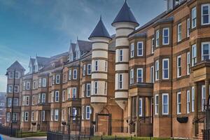 Modern brick apartment buildings with cylindrical towers in Tynemouth Beach photo