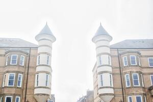 Symmetrical brick buildings with cylindrical towers photo