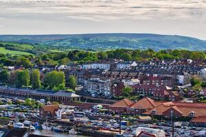Aerial view of coastal town with harbor and rolling hills in Whitby, North Yorkshire photo