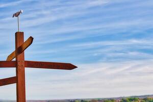 Wooden signpost with directional arrows under blue sky in Whitby, North Yorkshire photo