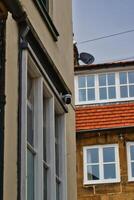 Security camera on building corner Robin Hood's Bay, Yorkshire photo