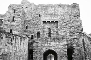 Black and white photo of an old stone castle in Tynemouth Priory and Castle