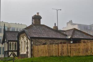 Quaint Stone Cottage on a Foggy Day photo