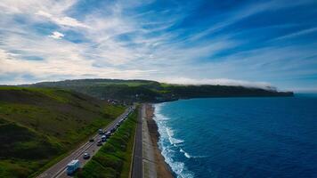 Scenic coastal road with ocean and green hills in Sandsend, Yorkshire photo