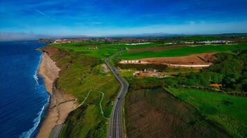 Aerial view of coastal road and green fields in Sandsend, Yorkshire photo