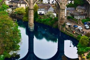 Ancient Bridge Reflection in Quaint Village in Knaresborough, North Yorkshire photo
