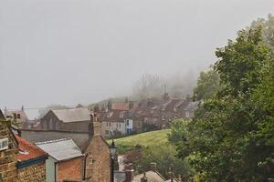 brumoso Mañana en un pequeño pueblo Robin capucha bahía, Yorkshire foto