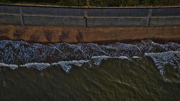 Aerial View of Ocean Waves and Seawall in Sandsend, Yorkshire photo