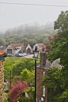 Foggy morning in a quaint village in Robin Hood's Bay, Yorkshire photo