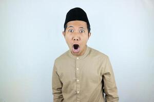 funny shocked and surprise expression asian muslim men wearing cap isolated on white background photo