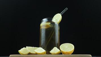 Glass of tasty Long Island iced tea on dark background with space for text photo