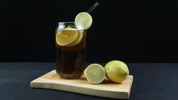 Glass of tasty Long Island iced tea on dark background with space for text photo