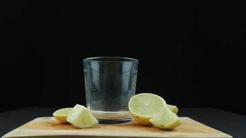 Fresh yellow lemon lime fruit with slices on wood cutting board on black background , Copy space photo