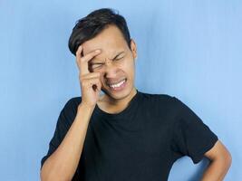 Handsome young man Hands holding head suffering from headache because pain and migraine. photo