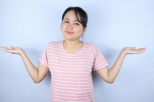 Portrait beautiful asian woman showing something with open hand palm smiling joyful and happy photo