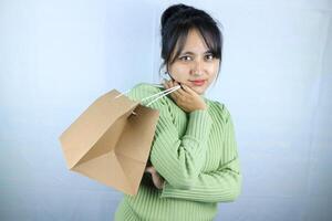beautiful asian woman holds craft bags, reflecting the happiness of finding discounts. photo