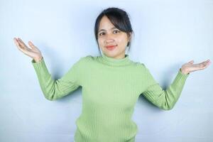 Portrait beautiful asian woman showing something with open hand palm smiling joyful and happy photo