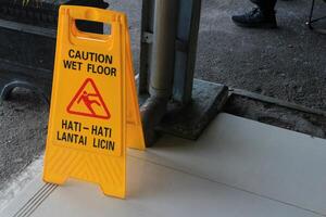 Sign showing warning of caution wet floor photo