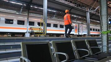 Semarang 17 April 2024 a train officer is controlling the tracks at an Indonesian railway station photo