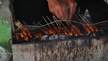 Sate ayam or chicken satay on traditional charcoal fire. Indonesia traditional food. photo