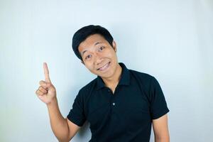 Asian man expression smiling while pointing to the side presenting the product. advertising concept photo