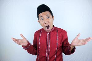 Surprised young Asian Muslim man looking camera, reacting ramadan news photo