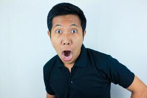 funny expression of shocked and surprised Asian man isolated on white background photo