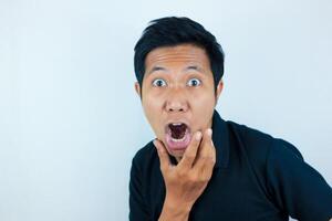 funny expression of shocked and surprised Asian man isolated on white background photo
