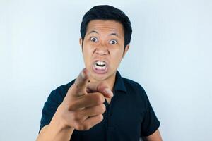 Who do you think you are. facial expression of angry asian man pointing at camera photo