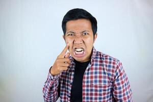 Asian man's annoyed expression touches his cheek because he is chubby photo