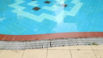 Overflow grating of swimming water pool. photo