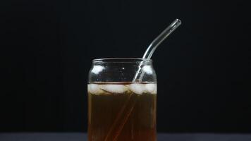 Glass of tasty Long Island iced tea on dark background with space for text photo
