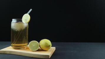 Glass of tasty Long Island iced tea on dark background with space for text photo