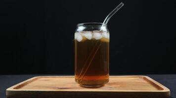 Glass of tasty Long Island iced tea on dark background with space for text photo