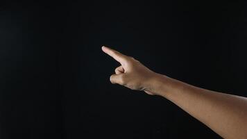 Closeup of male hand pointing. Isolated on black background photo